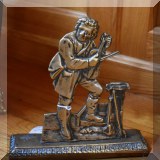 D10. Brass doorstop.